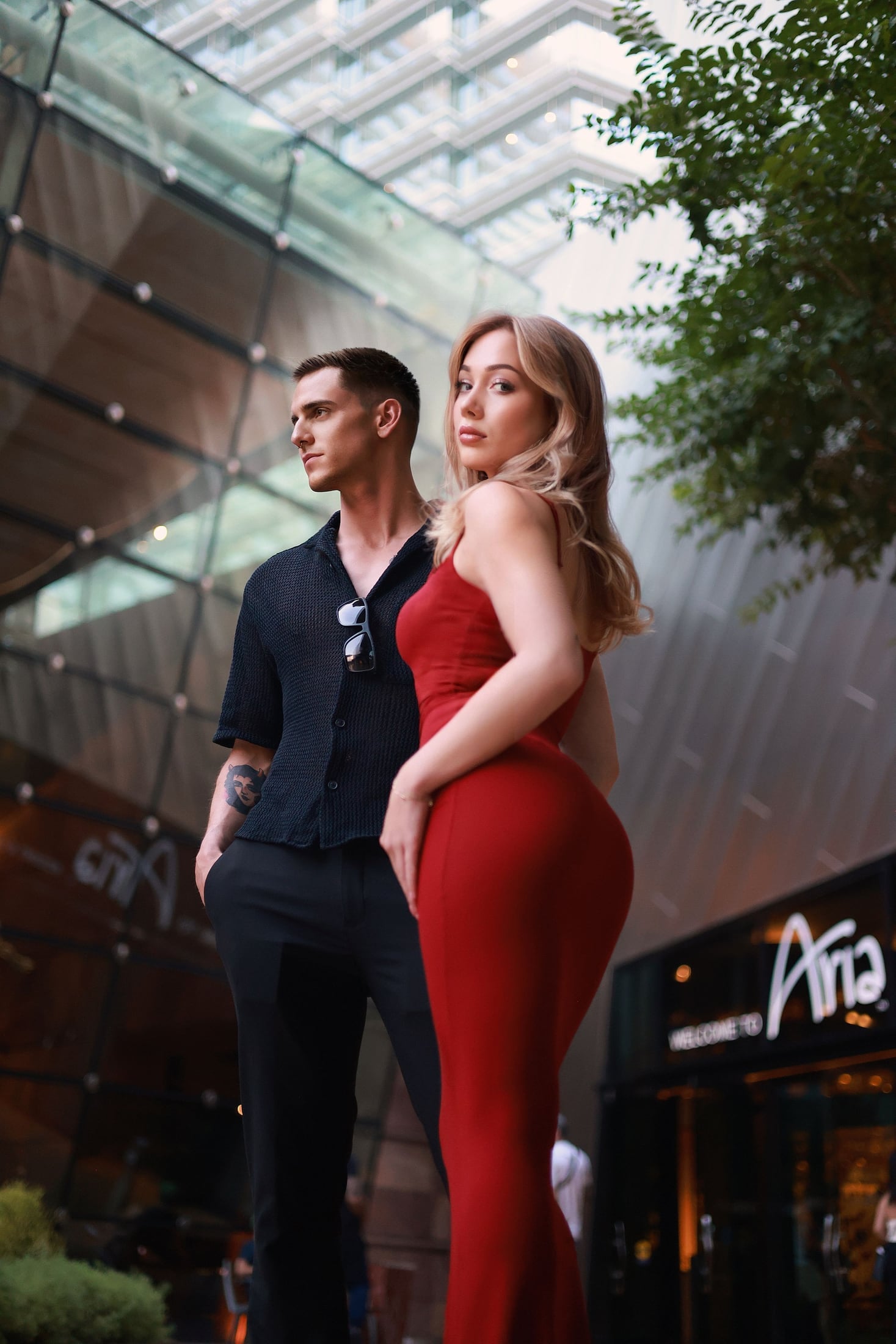 Couple outside a lit hotel entrance at night